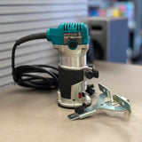 Close-up of Makita RT0701C model label showing factory serviced router