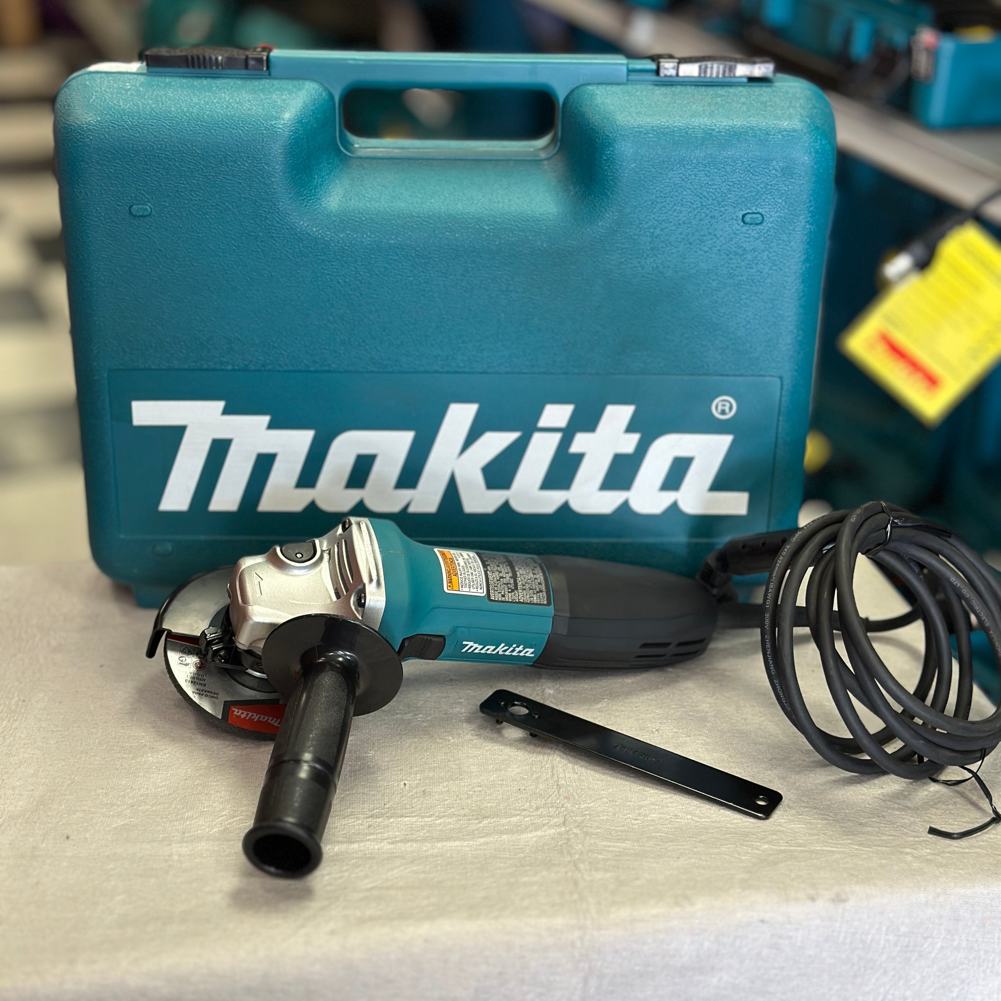 Makita 6 Amp Corded 4 in. Lightweight Angle Grinder with Grinding Wheel, Wheel Guard Side Handle Hard Case