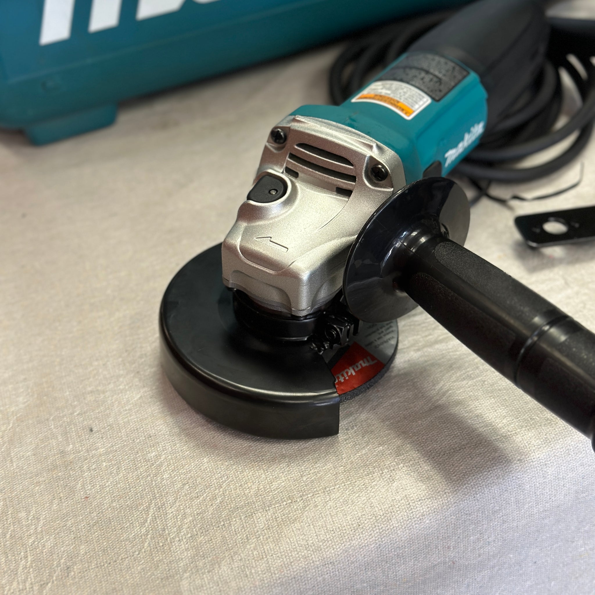 Makita 6 Amp Corded 4 in. Lightweight Angle Grinder with Grinding Wheel, Wheel Guard Side Handle Hard Case